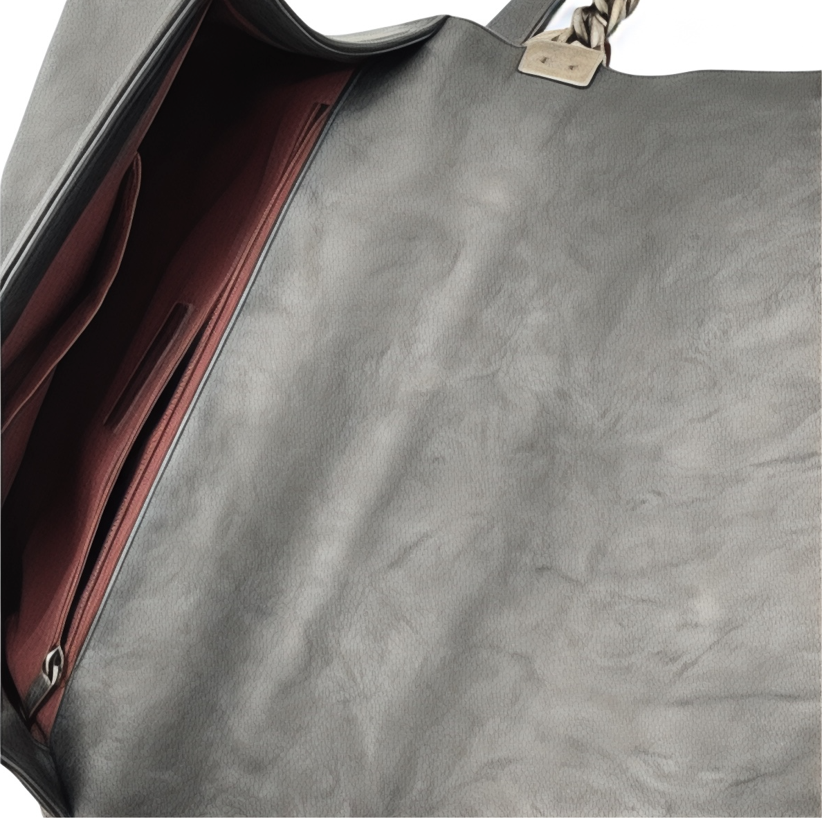 Inside black leather Chanel Boy bag with a zipper, showing texture and color.