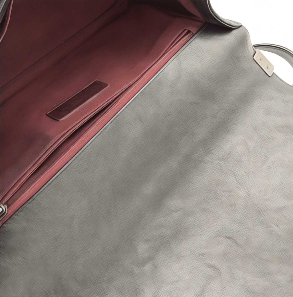 Close-up of  interior of  black  Chanel Boy bag showing inside flap  surface with a red interior