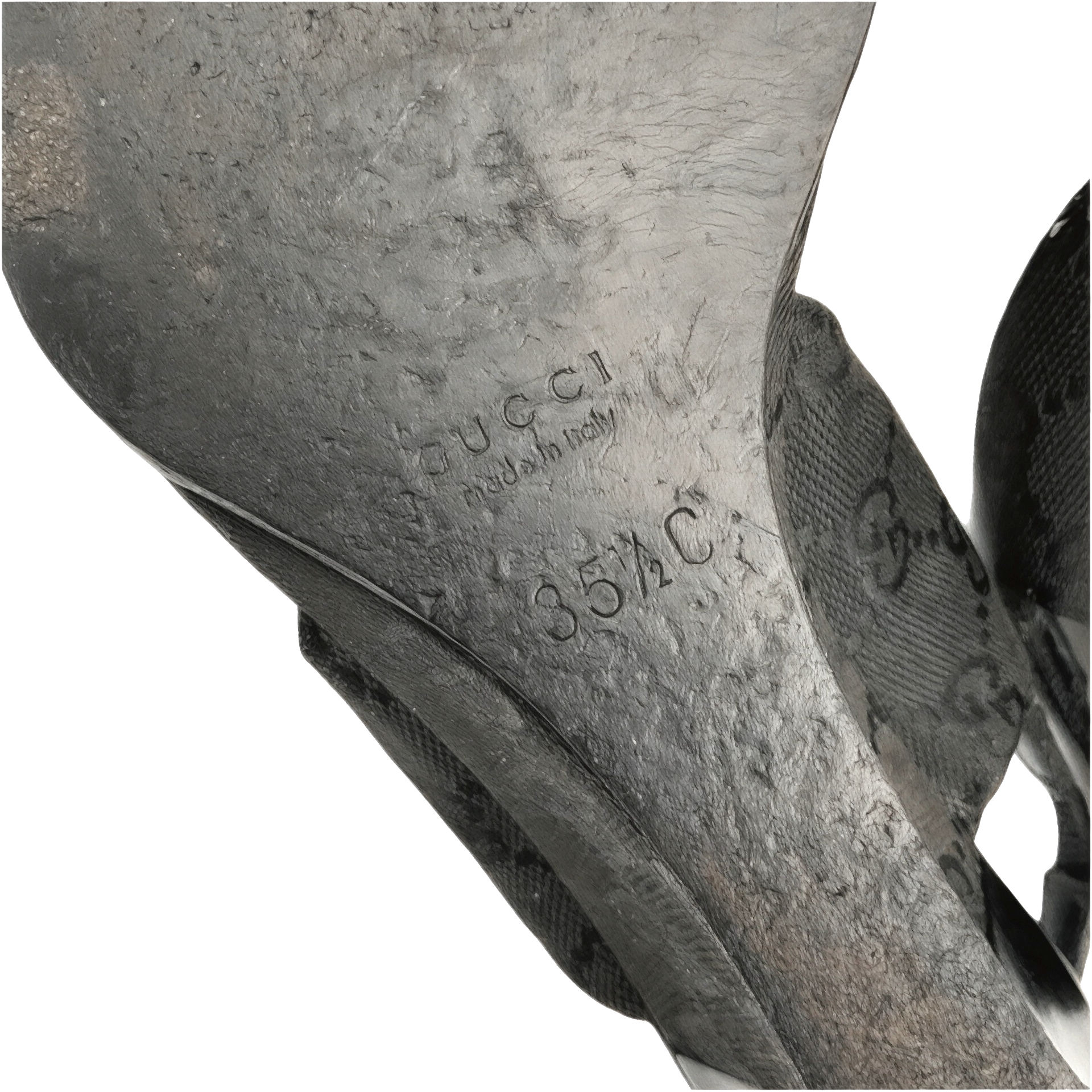 Close-up of bottom of Gucci monogrammed sandal sole with brand name and size marking.