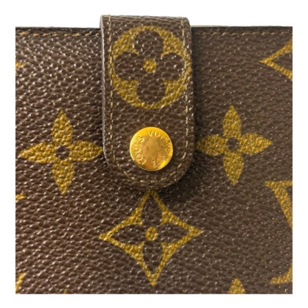 Cartera larga plegable con monograma y cierre de beso de Louis Vuitton